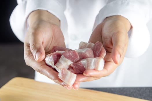 close up chef holding streaky pork