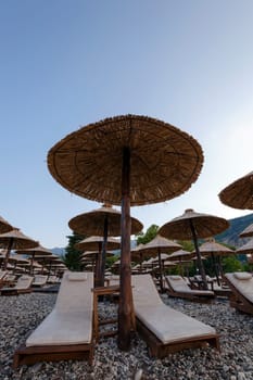 the wooden umbrellas located on a beach. Montenegro