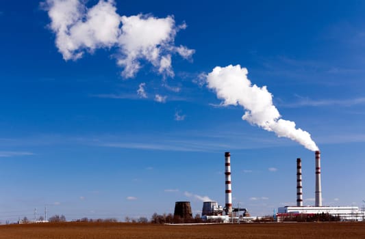 emissions from industrial plants against the blue sky.