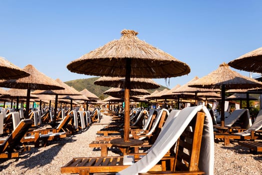 the photographed wooden umbrellas located in the territory of a beach