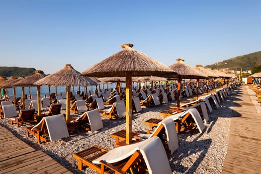 the photographed wooden umbrellas located in the territory of a beach