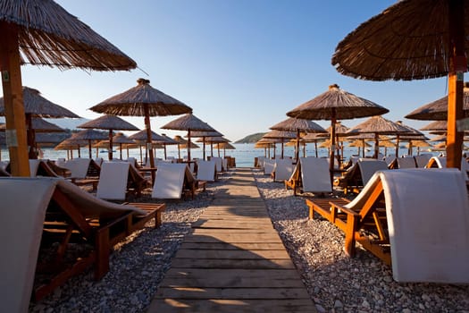 the photographed wooden umbrellas located in the territory of a beach