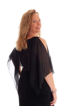 A smiling woman standing isolated for white background from the.waist up in a black dress and looking over her shoulder..