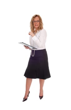 A business woman standing in a black skirt white blouse holding.her clipboard standing isolated for white background..