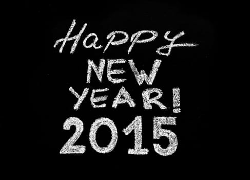 Happy new year 2015, hand writing with chalk on blackboard, isolated on black background, vintage concept