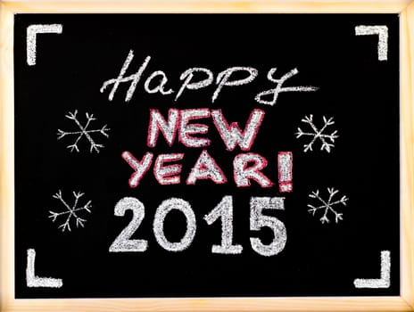 Happy new year 2015, hand writing with chalk on wooden frame blackboard, vintage concept