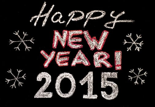 Happy new year 2015, hand writing with chalk on blackboard, isolated on black background, vintage concept