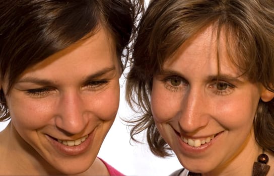 Two sisters looking down surprised and happy