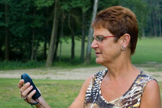 woman using a gps on a hike in the woods