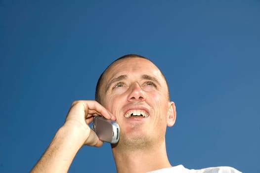 Boy looking happy after what he heard on his mobile