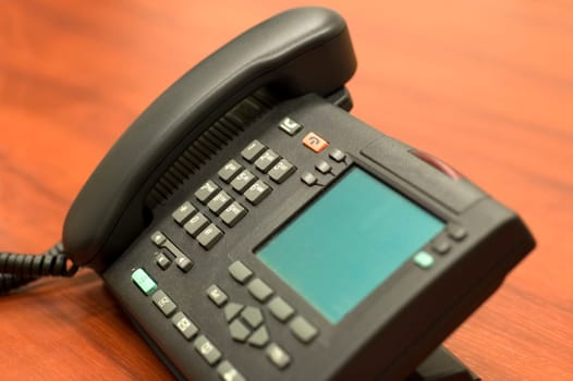 Business phone with blank lcd-screen. Focus is on the digits.