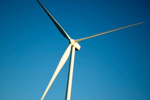 Windmill in front of a clear blue sky.