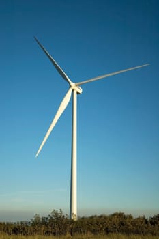 Windmill in front of a blue sky.