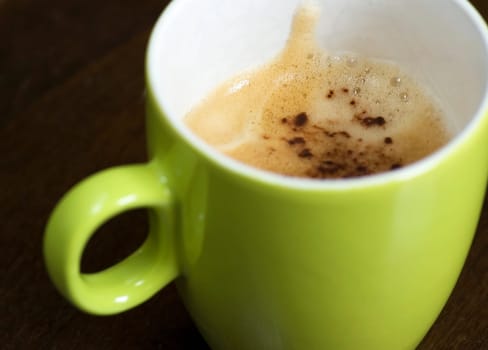 A delicious cup of cappuchino on a table.