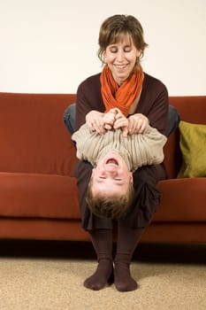 Mother playing with her son on the couch. Nice family picture.