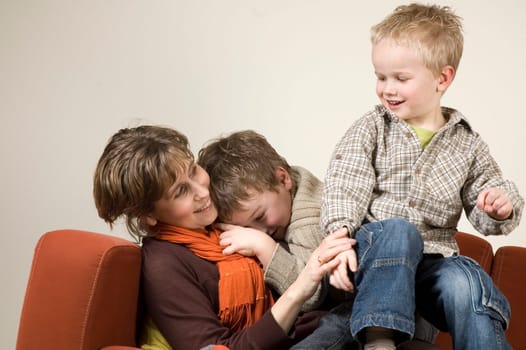 Family playing pranks on a couch.
