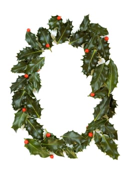 Holly Leaves with berry's in the form of the letter Q. Isolated on white.