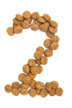 Little ginger nuts in the form of the digit two. These little ginger nuts are used in Holland for the "Sinterklaas"" party, which is at Dec 5 every year. Sinterklaas is a sort of Santa Claus. In Holland these ginger nuts are called ""pepernoot"". Isolated on white."