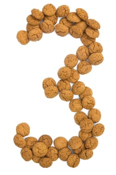 Little ginger nuts in the form of the digit three. These little ginger nuts are used in Holland for the "Sinterklaas"" party, which is at Dec 5 every year. Sinterklaas is a sort of Santa Claus. In Holland these ginger nuts are called ""pepernoot"". Isolated on white."