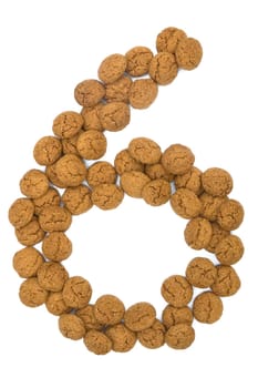 Little ginger nuts in the form of the digit nine. These little ginger nuts are used in Holland for the "Sinterklaas"" party, which is at Dec 5 every year. Sinterklaas is a sort of Santa Claus. In Holland these ginger nuts are called ""pepernoot"". Isolated on white."