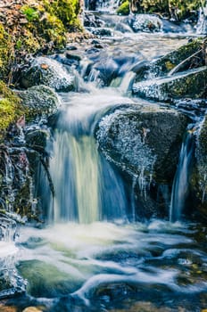 The flow of water in the spring of icicles and ice