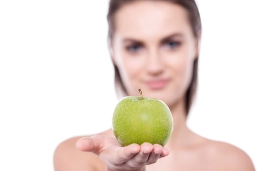 Close up of young woman posing to camera with an apple in her hand