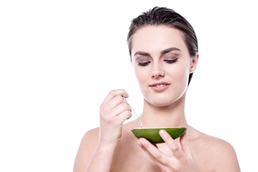 Woman ready to eat the fruit using spoon