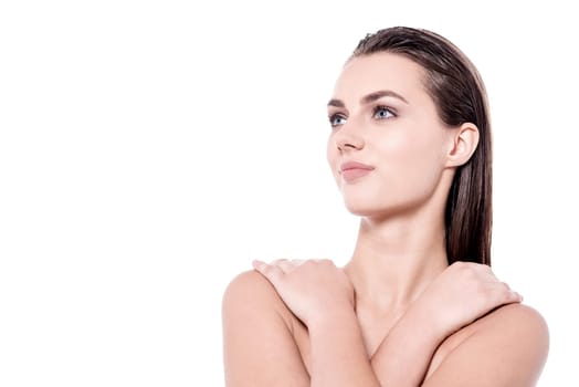 Pretty woman hugging herself over white background
