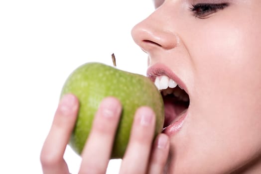 Close up image of a woman eating a green apple