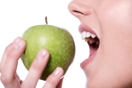 Cropped image of a woman trying to consume a green apple