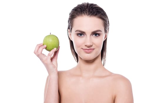 Young woman showing an apple to camera
