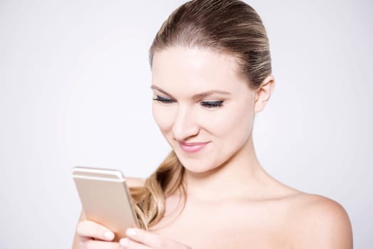 Gorgeous woman with a touch screen phone