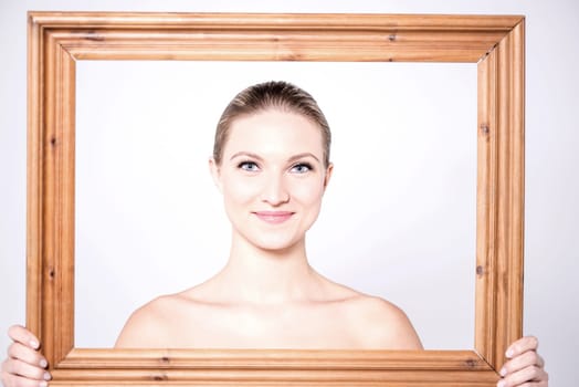Sensual women posing from behind wooden frame