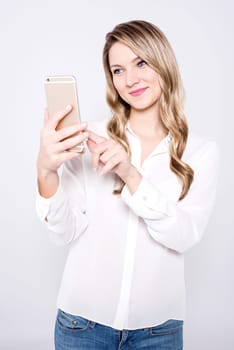 Trendy woman clicking a selfie with smartphone