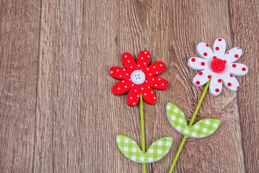 Creative handmade flowers on a brown wooden background