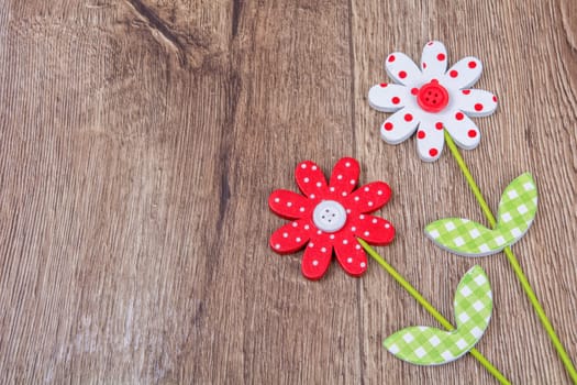 Creative handmade flowers on a brown wooden background