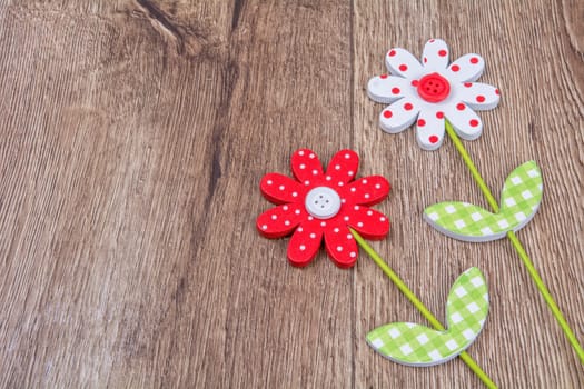 Creative handmade flowers on a brown wooden background