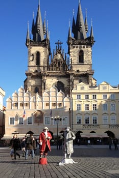 PRAGUE, CZECH REPUBLIC - NOVEMBER 13, 2012 - Live statues street artists perform in front of the Church of Our Lady before Tyn at the Old Town Square of Prague in the Czech Republic.
