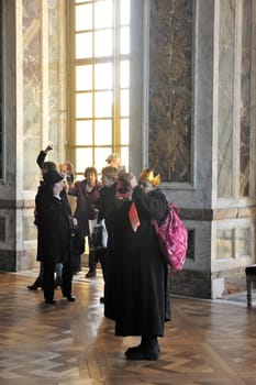 tourists visiting the castle of Versailles