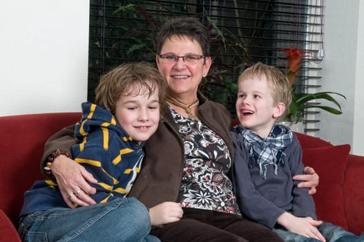 Family with two brothers and grandma in a livingroom
