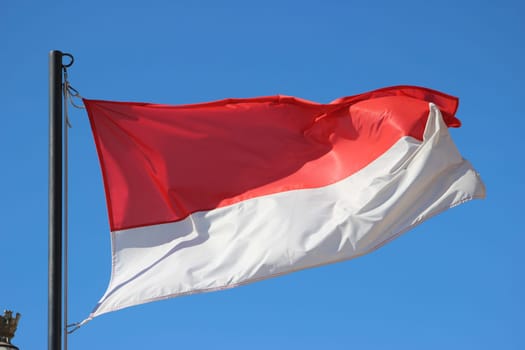 Monaco Waving Flag Against Blue Sky .