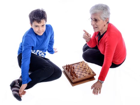 Grandmother with her grandson playing chess. white background.