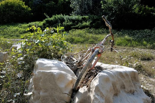 Bike carried away by the water and seen the bed of the river Gardon completely dry during the summer in the French department of Gard in the south-east