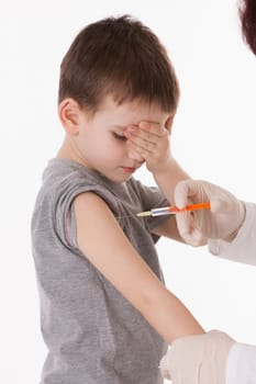 Doctor giving a child injection in arm on isolated image.