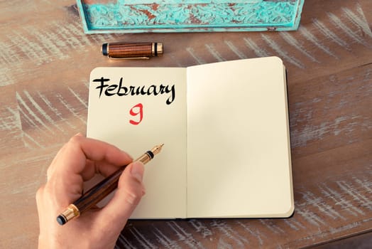 Concept image of February 9 Calendar Day with empty space for text as handwritten note with fountain pen on a notebook