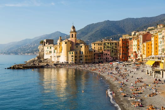 Panoramic view of a seaside town in the foreground beach an church in the background on a sunny day