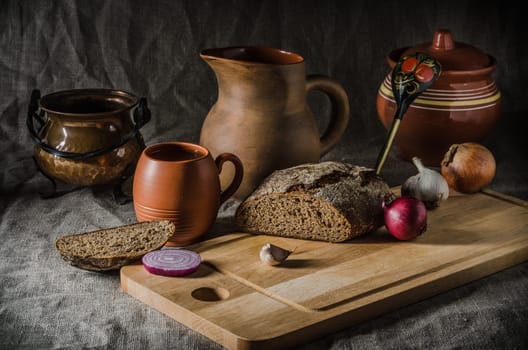 Still life with homemade bread and pottery