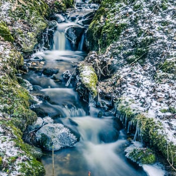 The flow of water in the spring of icicles and ice