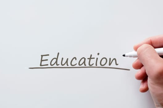 Human hand writing education on whiteboard