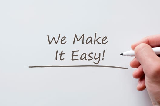 Human hand writing we make it easy on whiteboard
